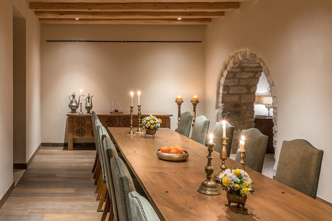 Elegant dining room with a long wooden table and candlelight.