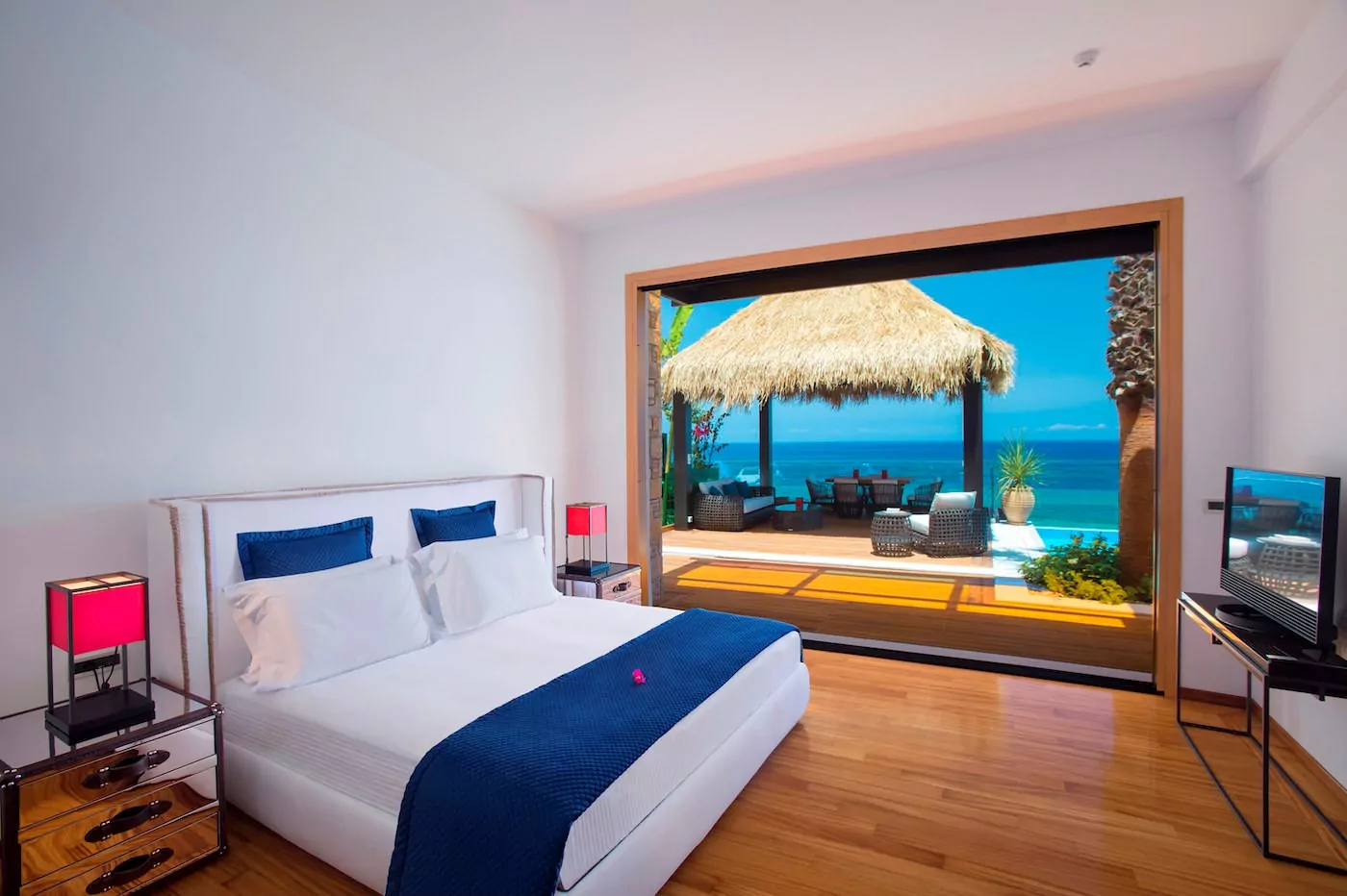 Luxurious bedroom with ocean view and private patio.