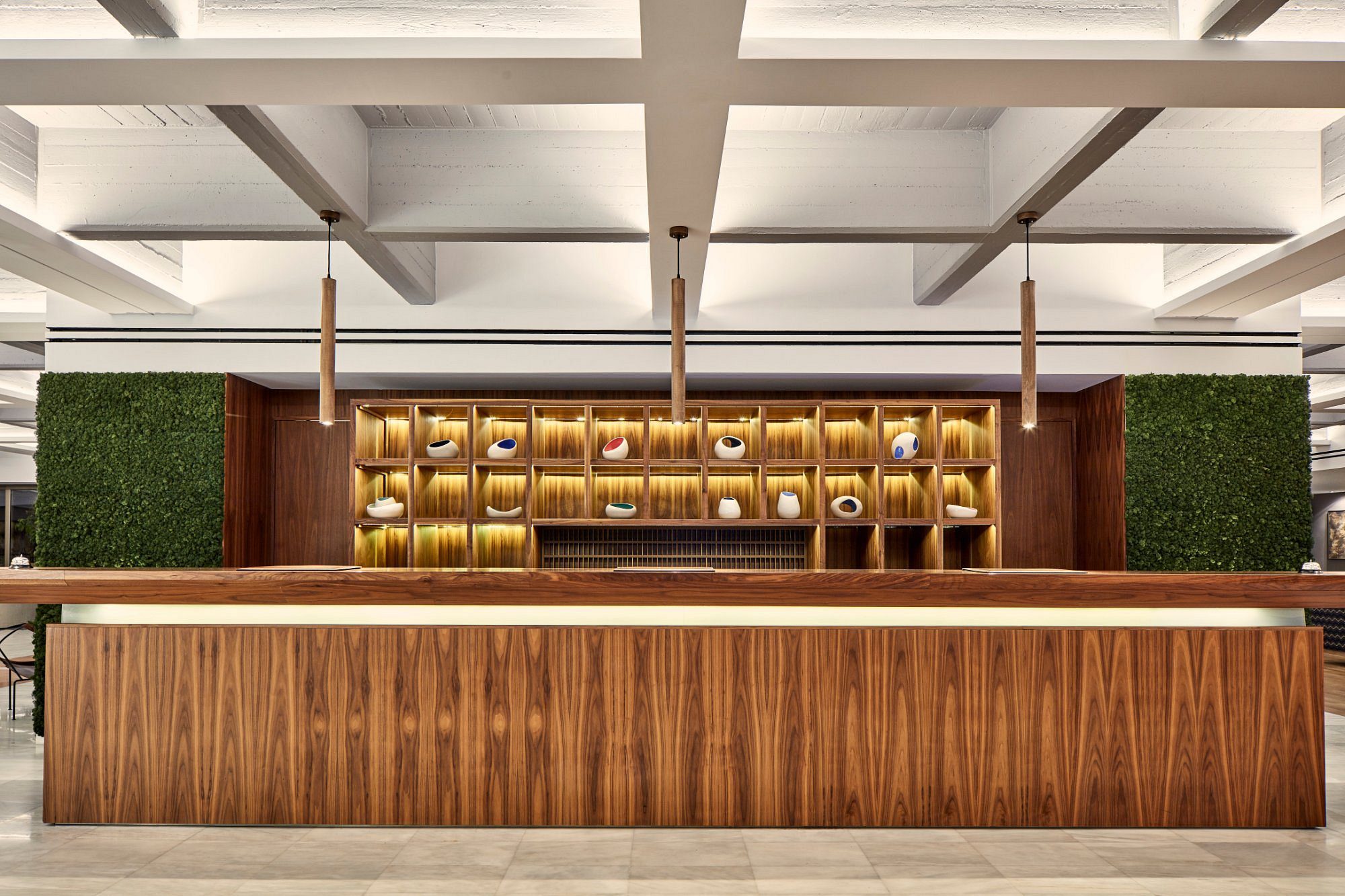 Elegant modern bar with wooden accents and golden shelves.