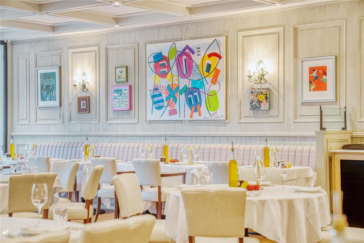 Elegant dining room with colorful abstract art on the wall.