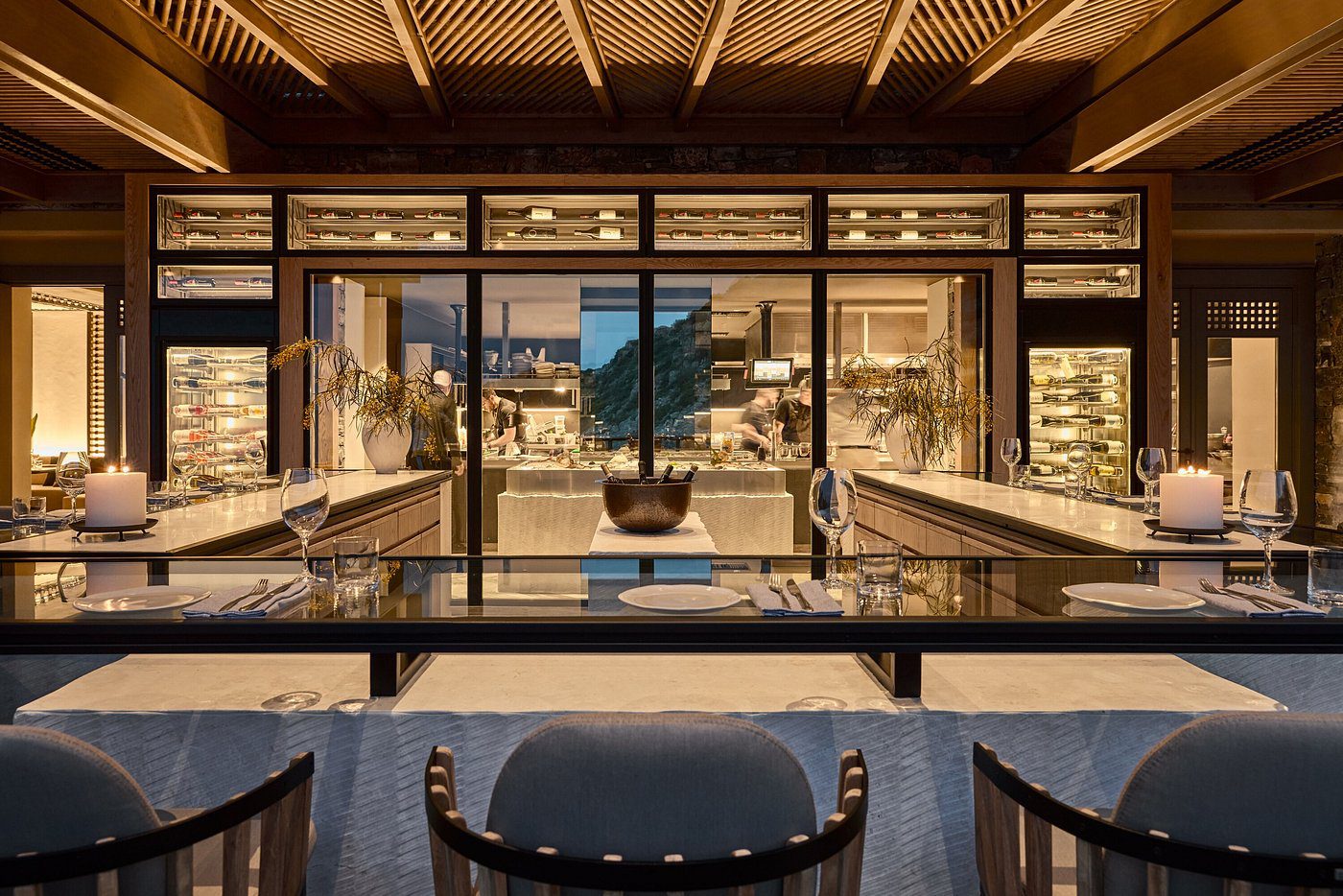 Luxurious modern dining area with elegant lighting and a central water feature.