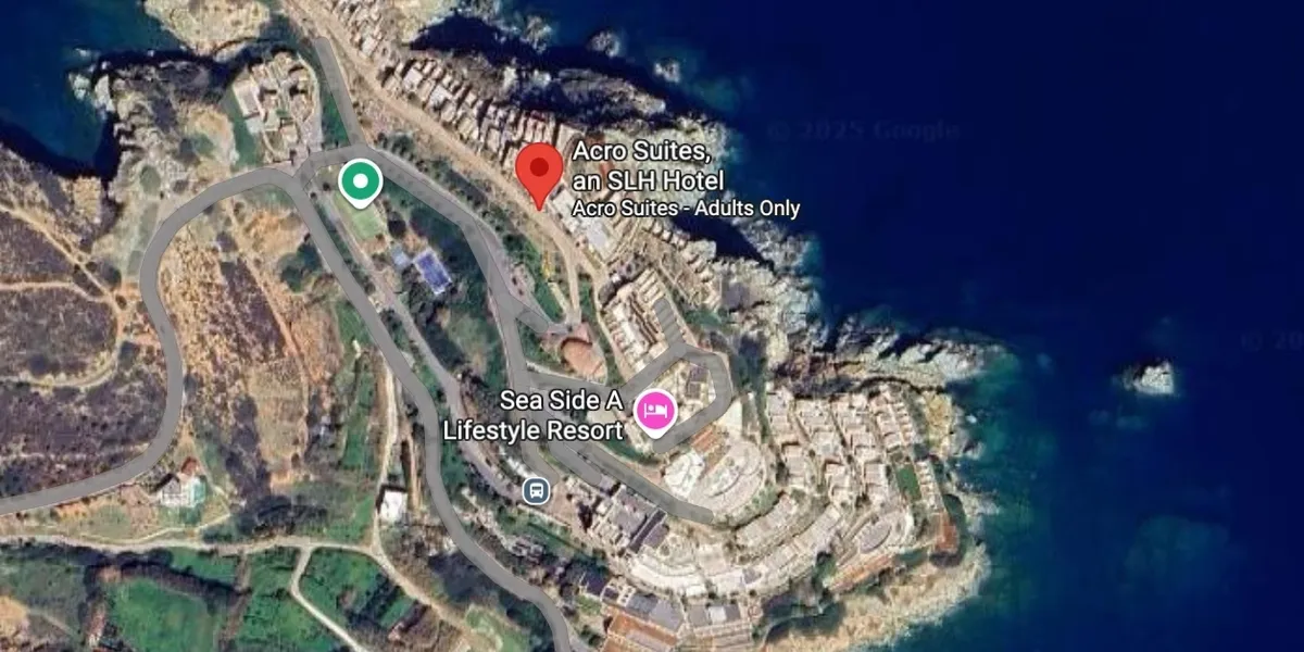A coastal residential area with clustered buildings near the sea.