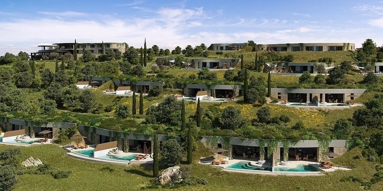 Modern villas with private pools surrounded by lush greenery under a clear sky.