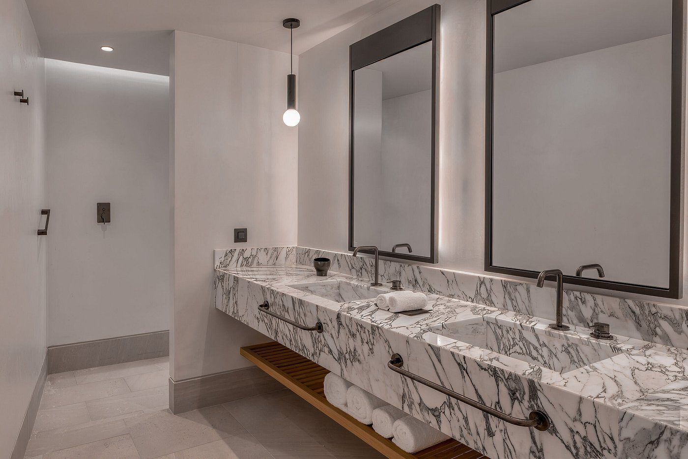 Modern bathroom with dual sinks and marble countertop.