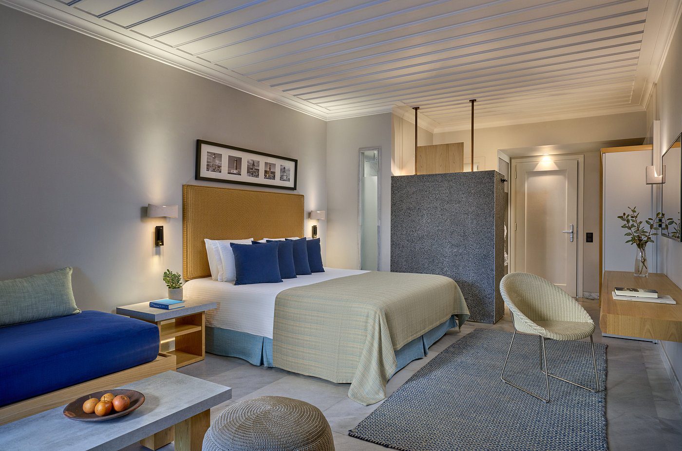 Elegant hotel room with king-sized bed and modern decor.