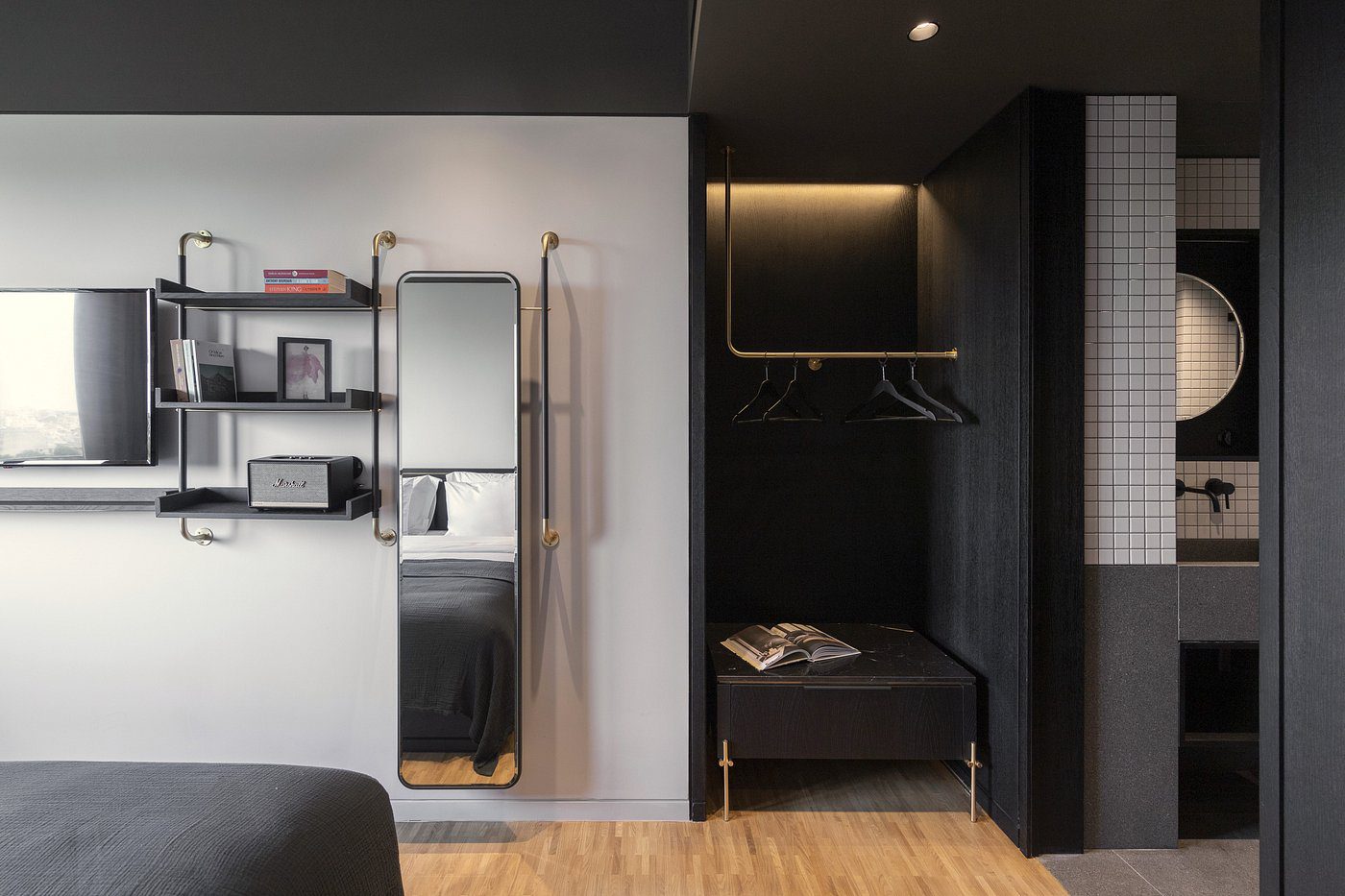Modern entryway with a wall-mounted mirror, shelves, and a seating bench.