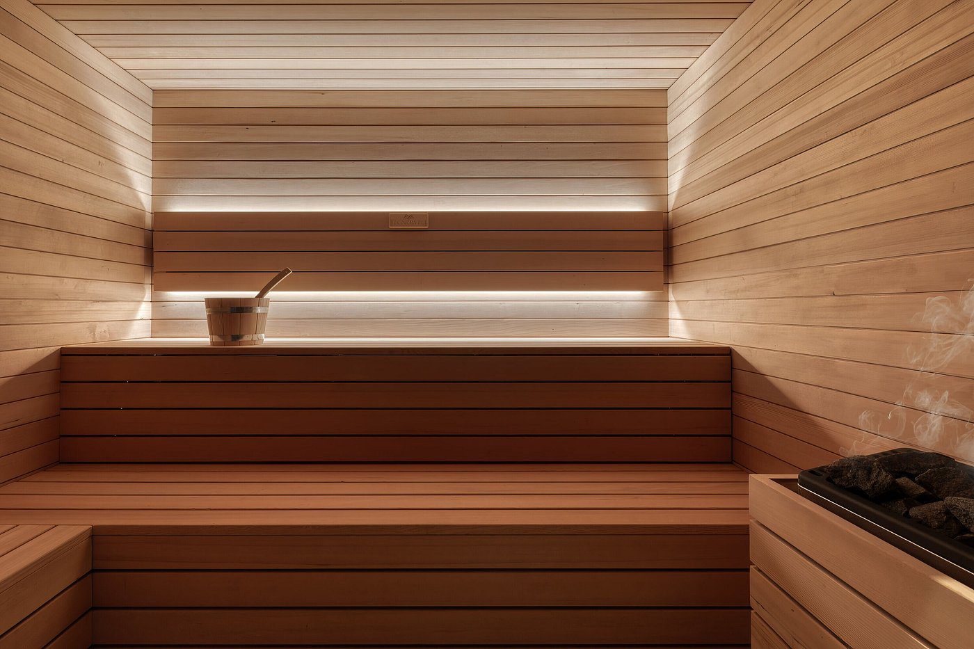 Modern wooden sauna interior with warm lighting and clean lines.