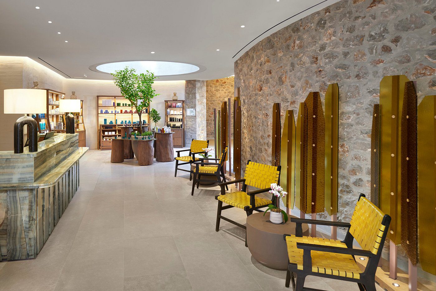 Elegant waiting area with yellow chairs and a stone accent wall.