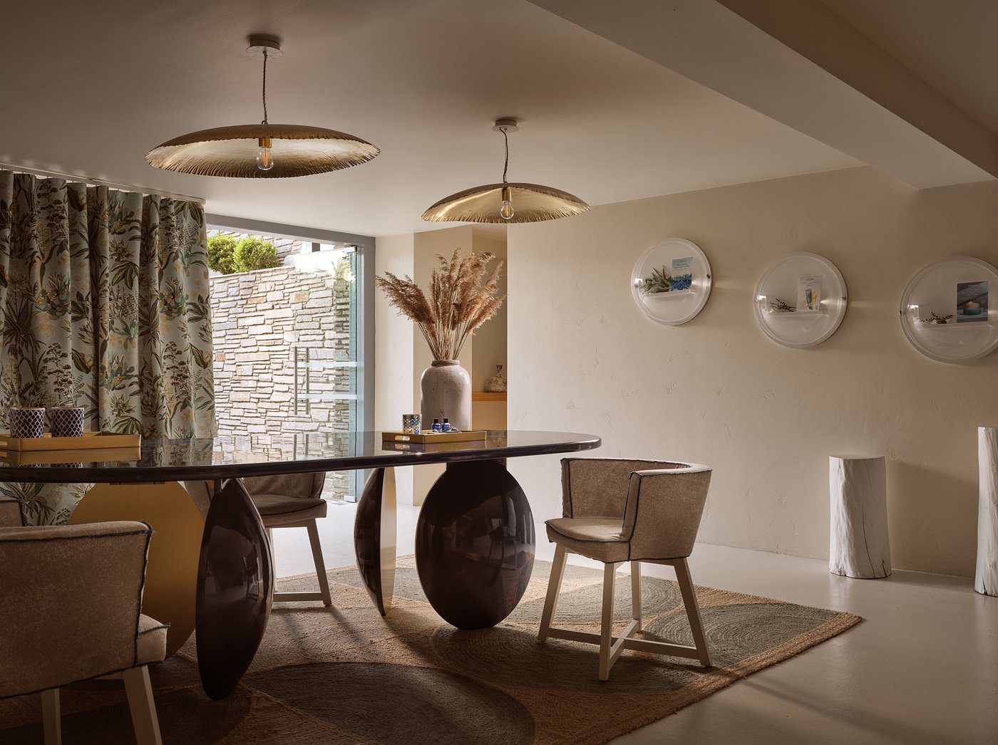 Elegant dining room with sculptural table and modern pendant lights.