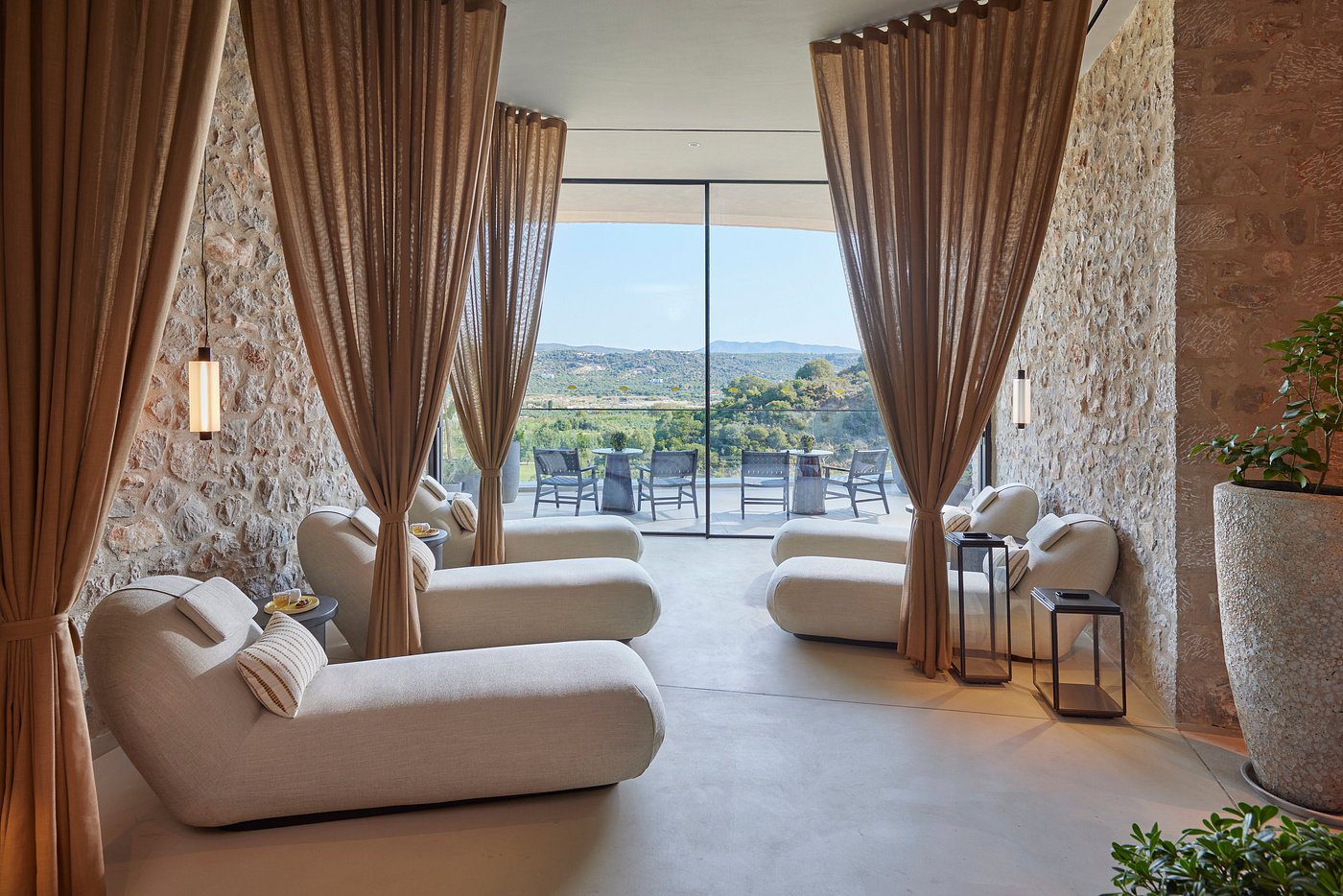 Modern lounge area with floor-to-ceiling curtains and a scenic balcony view.