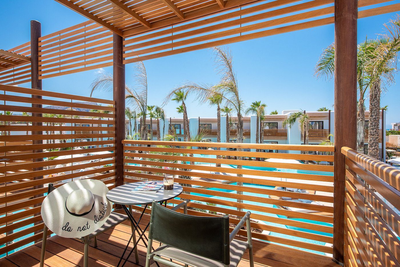 Balcony seating with wooden privacy screens and outdoor views.