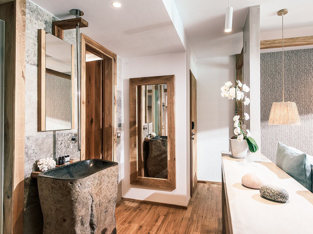 Modern bathroom with wooden accents and a large mirror.