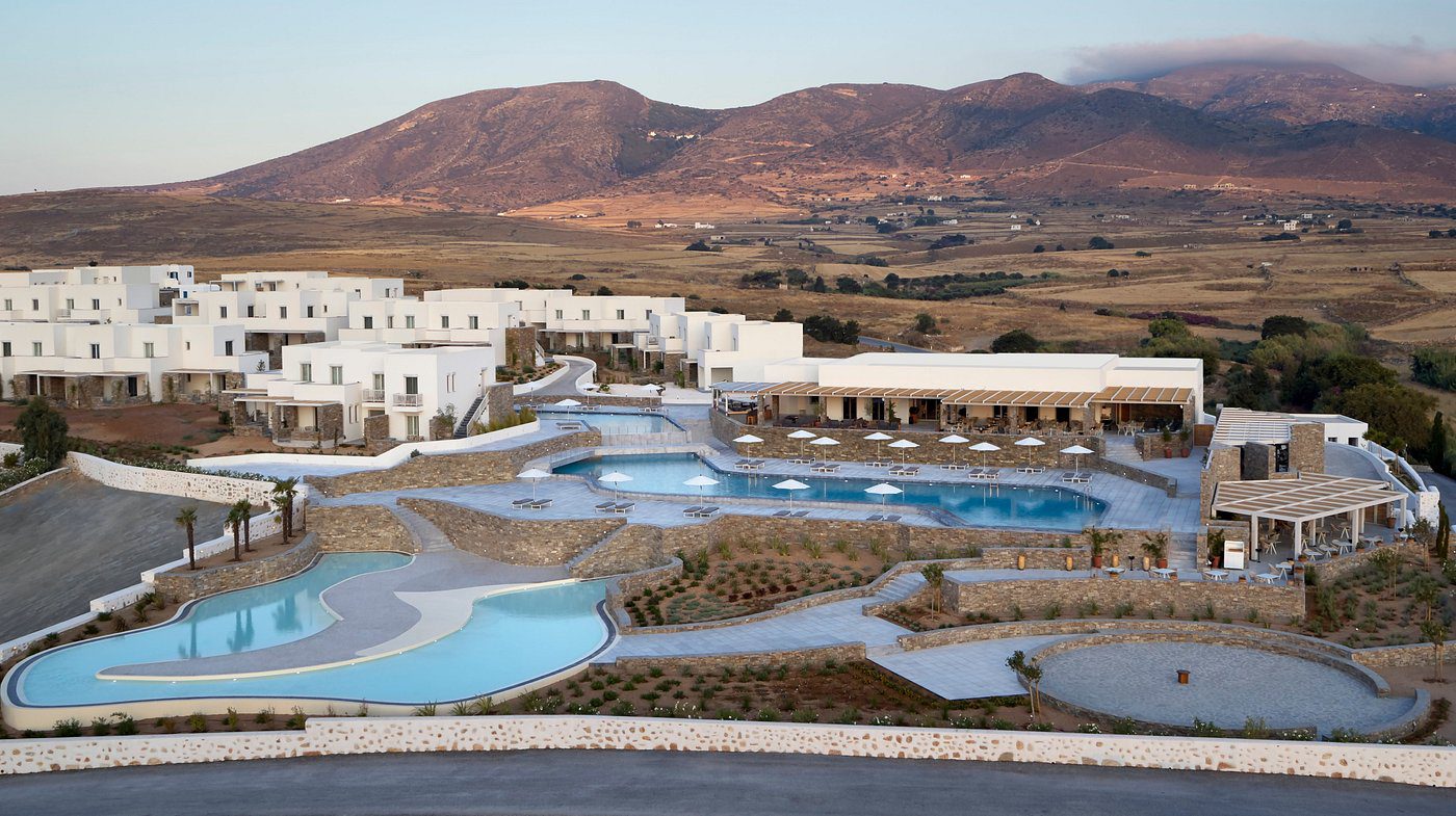 Luxury resort with pools in a desert mountain landscape.