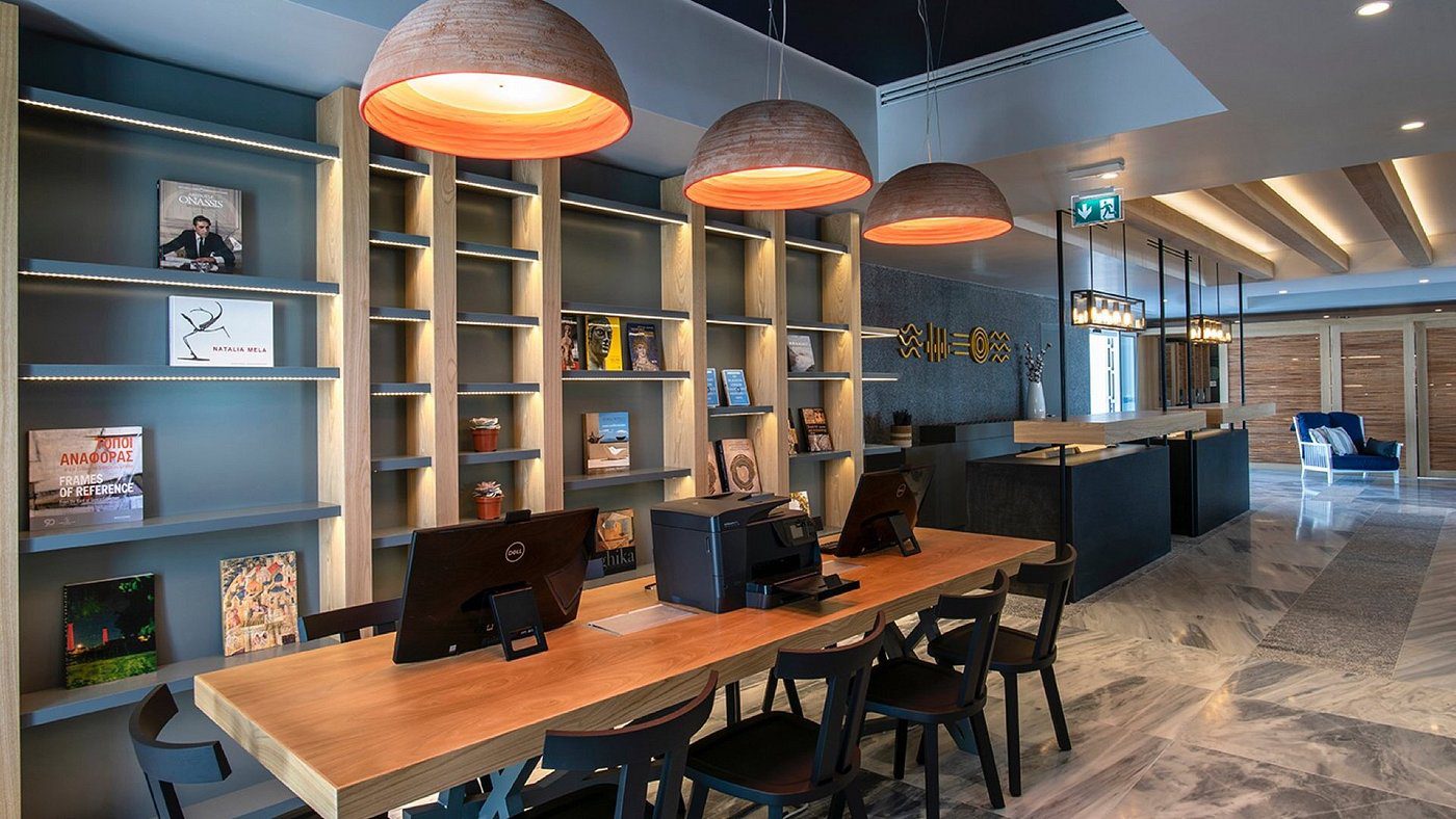 Modern co-working space with wooden desks and pendant lights.