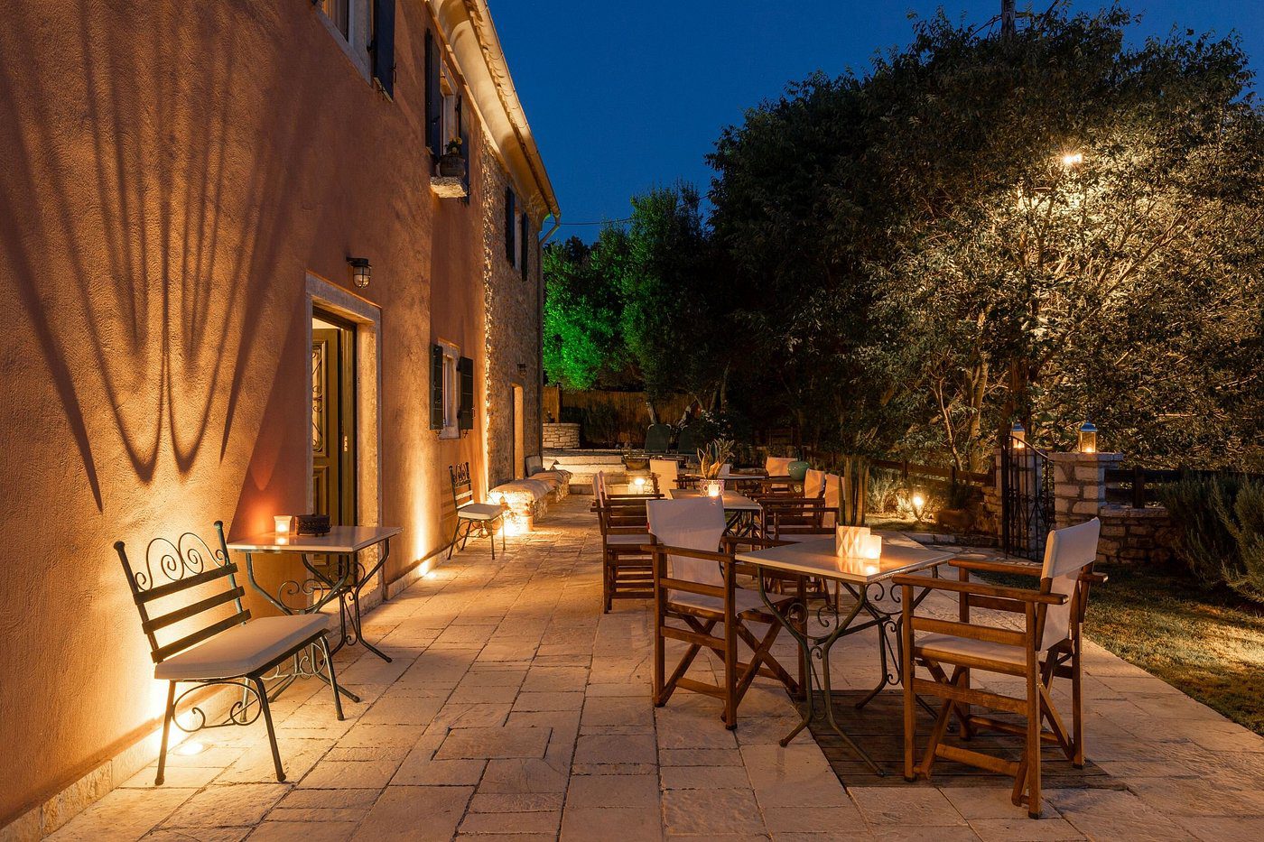 Cozy outdoor patio with warm lighting at night.
