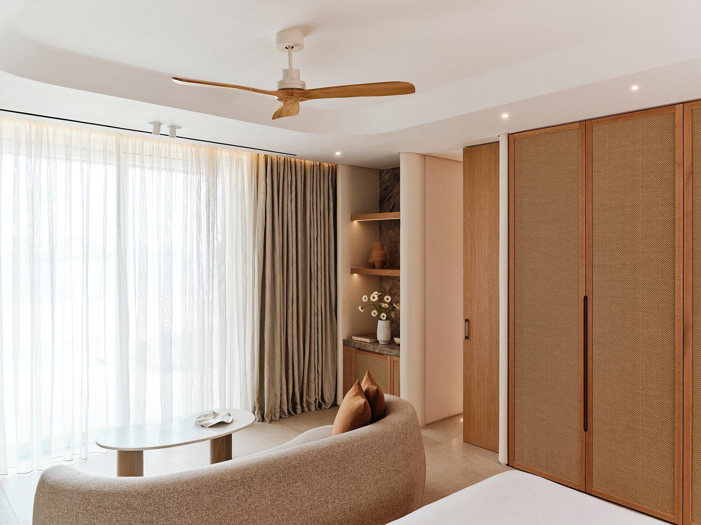 Elegant suite at Bill and Coo Mykonos featuring minimalist Cycladic design and sea-facing terrace.