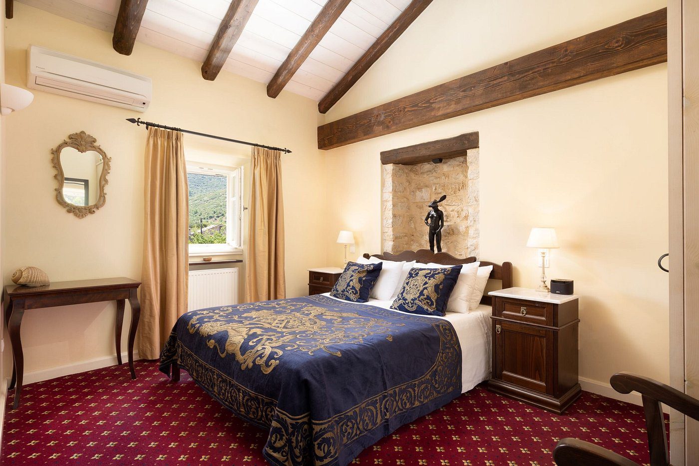 Cozy bedroom with wooden beams and elegant bedding.