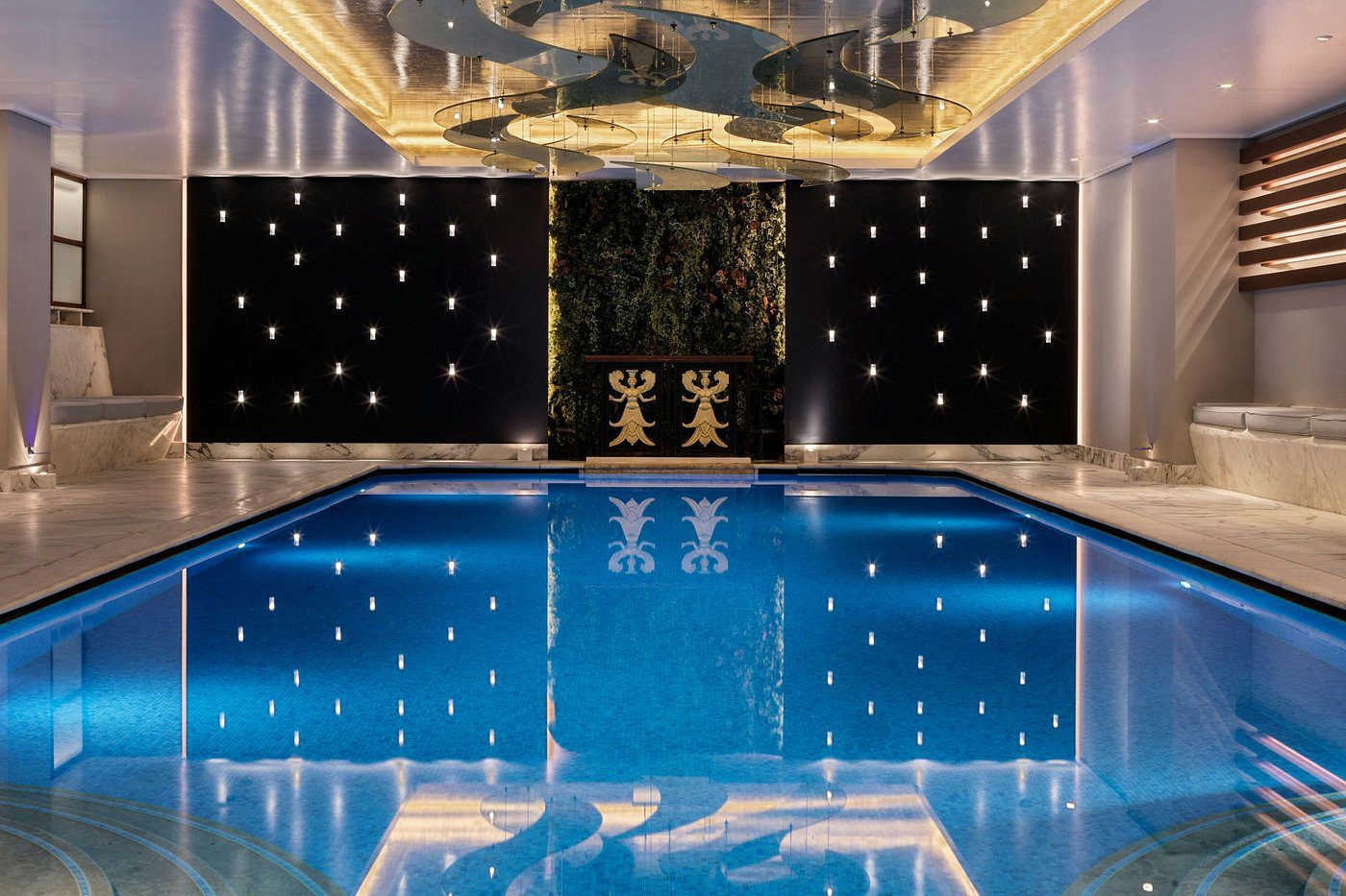 Luxurious indoor pool area with elegant lighting and decor.