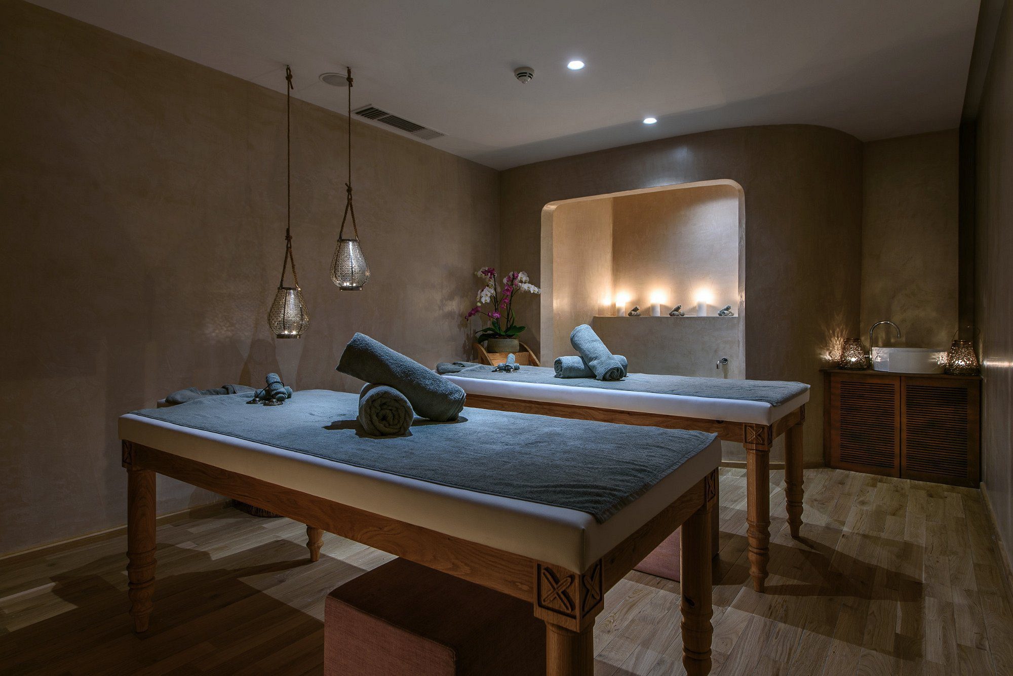 Calm spa room with massage tables and soft lighting.