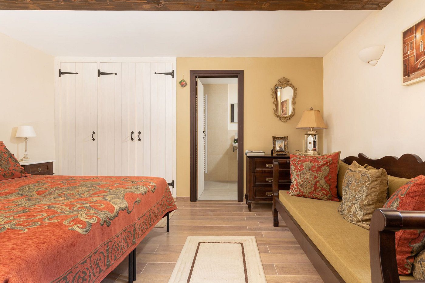 Cozy bedroom with warm tones and elegant wooden furniture.