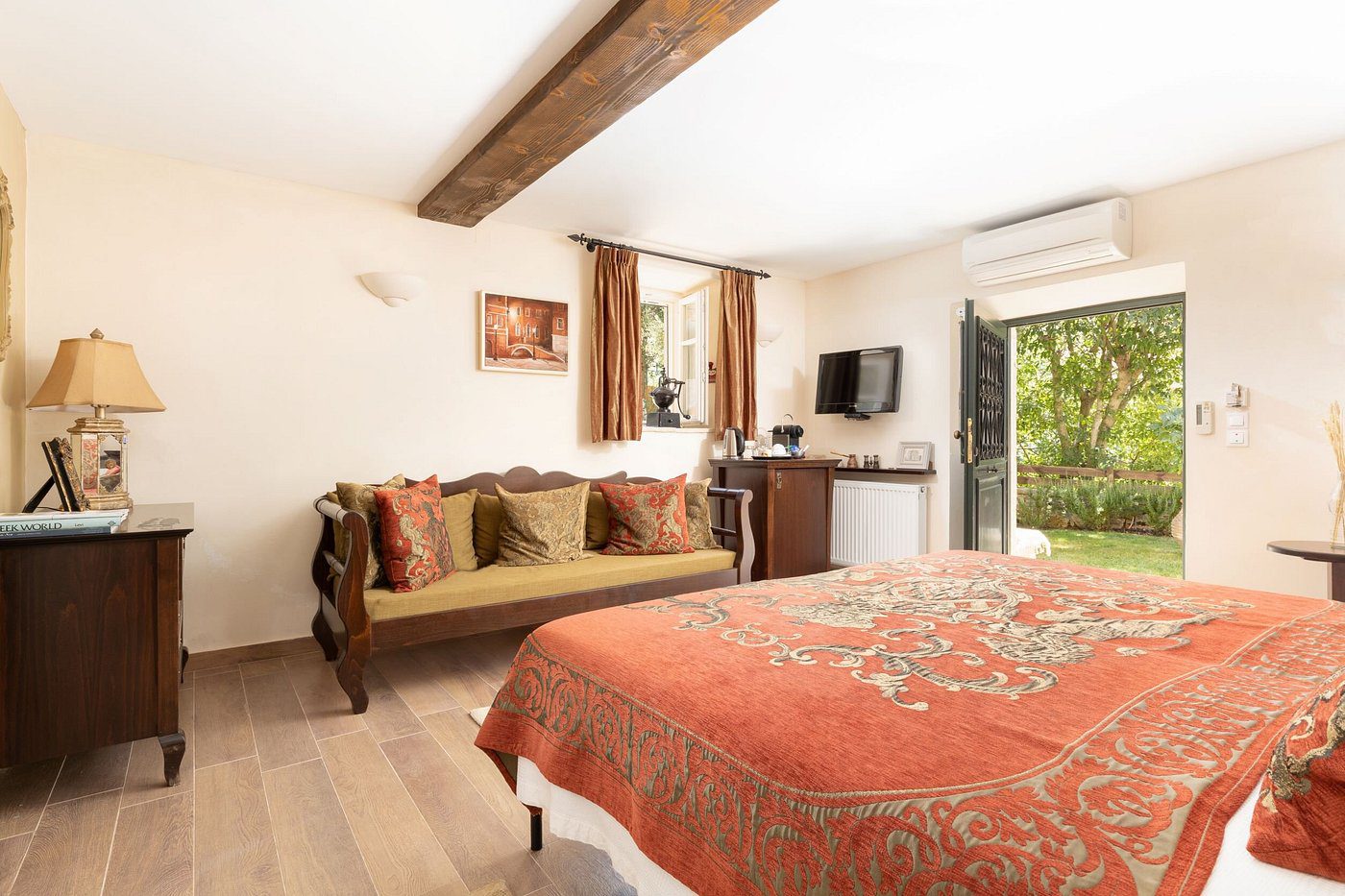 Cozy bedroom with rustic wooden beams and warm decor.