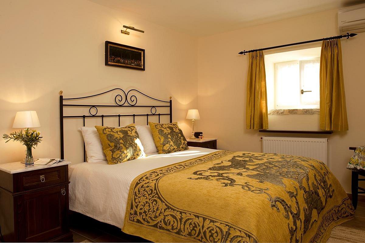 Cozy bedroom with elegant yellow and gold bedding and soft lighting.