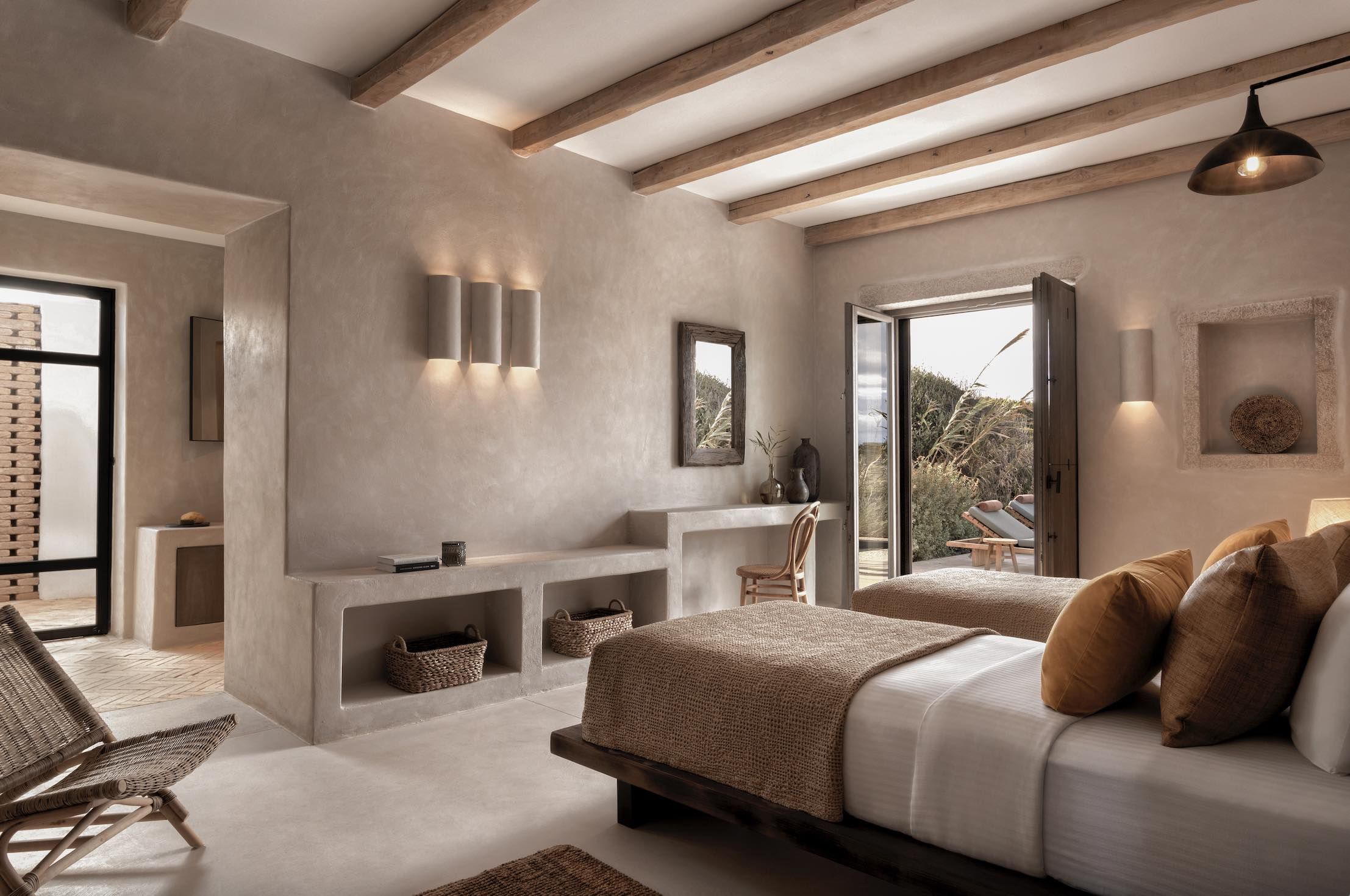 Minimalist bedroom with neutral tones and large windows.