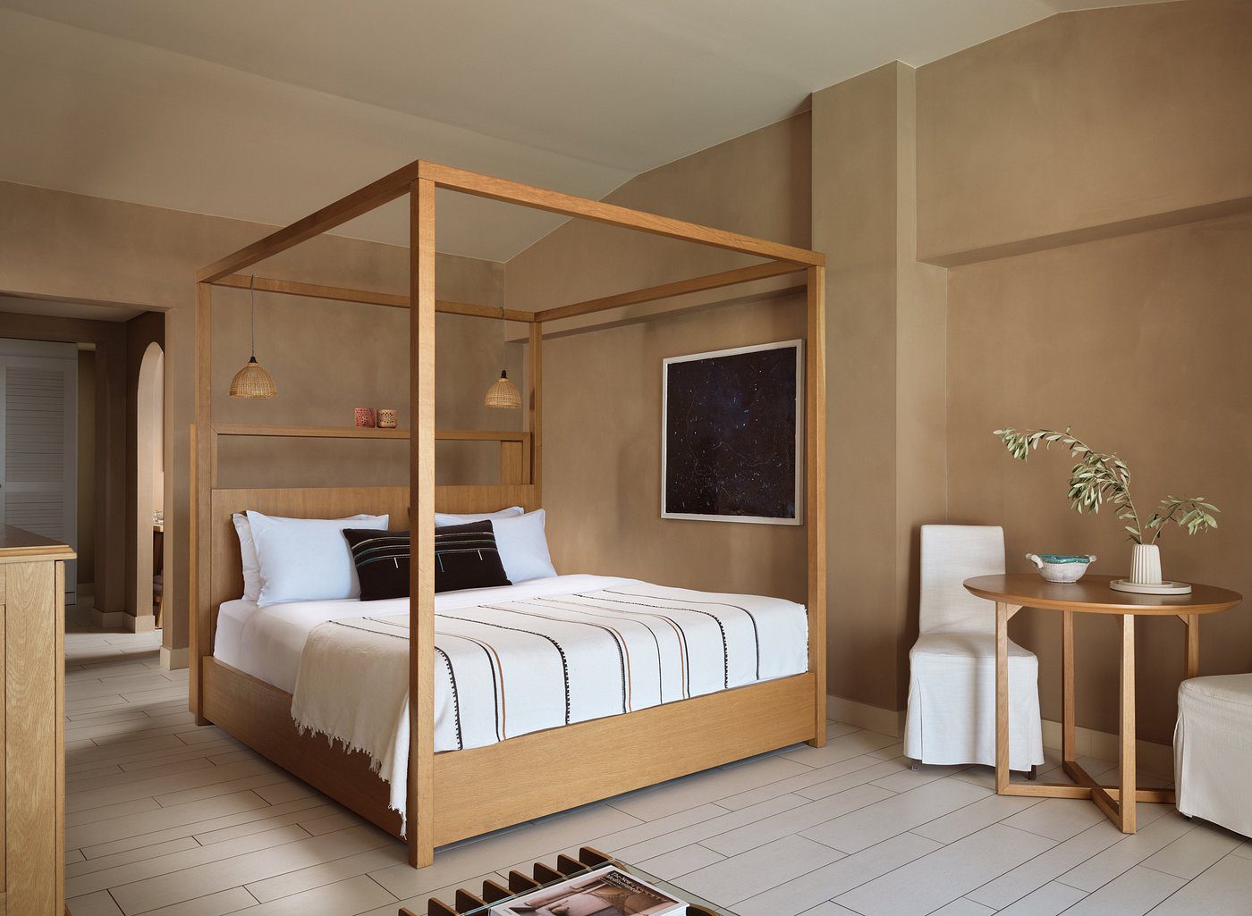 Elegant wooden canopy bed in a modern, neutral-toned bedroom.