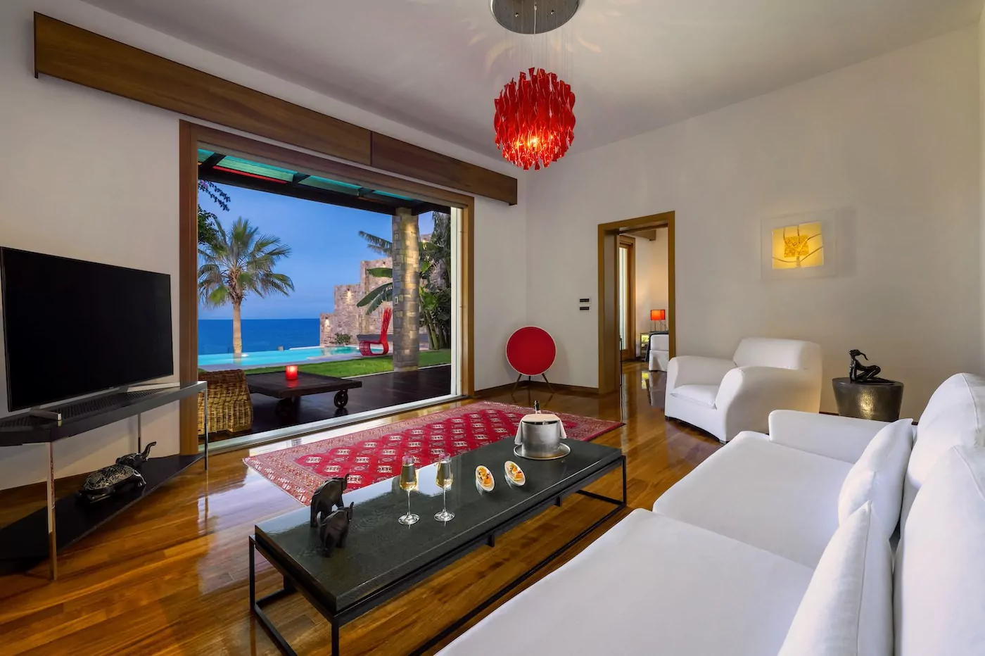 Cozy living room with ocean view and vibrant decor.