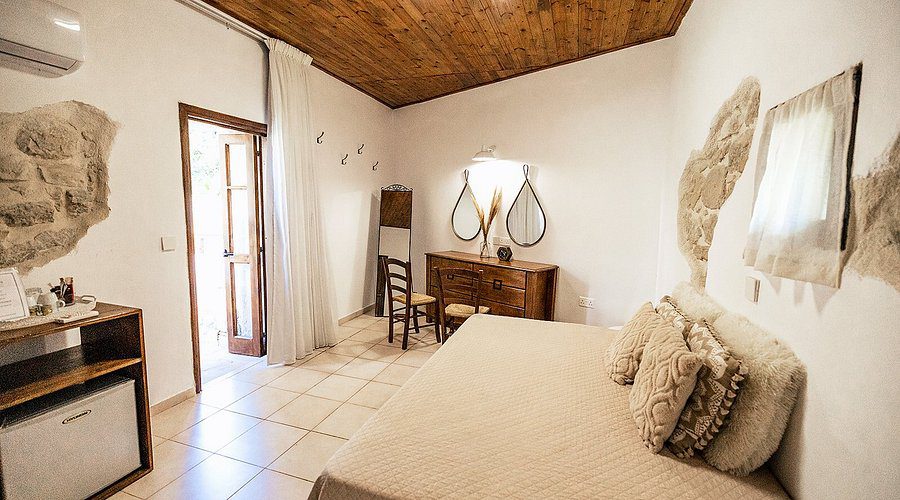 Cozy bedroom with wooden ceiling and vintage furniture.